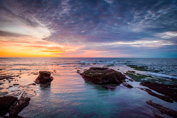 Cloudy sunset sky over the sea during twilight time