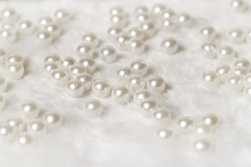 Romantic light pearl beads with white soft fur background