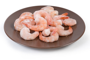 Prawn tails in ice glazing on brown dish close-up