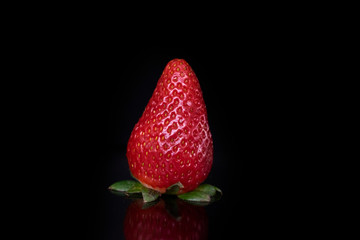 red fresh beautiful strawberry isolated on black background with soft light with empty place for text