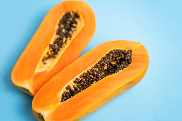 Ripe papaya on blue background