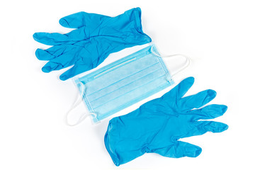 Medical mask and nitrile gloves on white background, top view