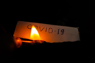 The names of the deadly virus in the world COVID-19 is written on a white sheet of paper and...