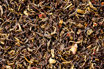 A mixture of black and green tea with vanilla-strawberry flavor, sliced strawberries and rose petals. Background for tea and antioxidants.