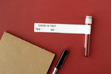 on a red background test tube with a test for coronavirus. Medical laboratory.