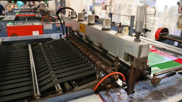 The operation of the side seal opp plastic bag cutting machine Closeup at the seal and cutting knife set in the concept of saving the world and the environment.