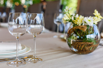 Wedding decor, wine glasses and champagne flutes on table. Selective focus