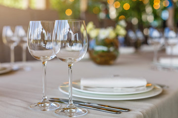 Wedding decor, wine glasses and champagne flutes on table. Selective focus