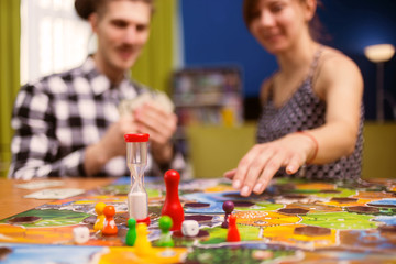 Board game concept- friends spend time together. Board game field, figures, dice, coins and...