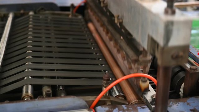 The operation of the side seal opp plastic bag cutting machine Closeup at the seal and cutting knife set in the concept of saving the world and the environment.
