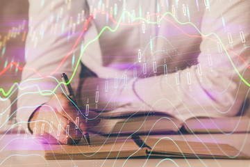 Financial trading chart double exposure with man desktop background.