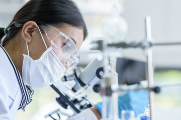Asian young girl student scientist researching  and learning in a laboratory.