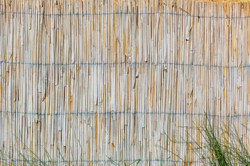 Wall from the tied up wooden planks