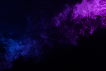 Multicolored smoke or fog blue and purple on black background