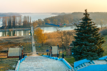 Early springtime landscape view of the river Don, a suspension bridge over the river Azovka and a stone stairs leading to the bridge. Azov, Rostov-on-Don region / Russia - 01 march 2013