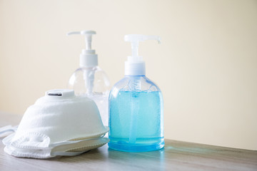 Coronavirus disease (COVID-19) prevention set, medical surgical face masks and hand sanitizer gel bottle for hand hygiene, health care concept.