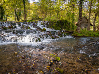 Cascades on the Janj mountain stream in the forest, painted with autumn colors near Sipovo. - Image