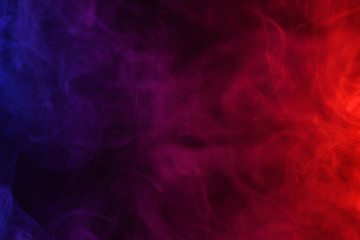 Blue pink and red smoke flowing dark abstract background