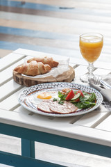 breakfast of fried eggs, croissants