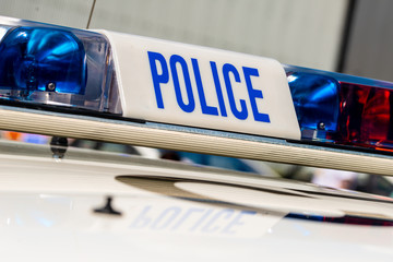 View of POLICE sign with lights, atop an emergency response patrol vehicle.