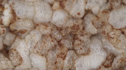 Macro footage of cereal crops, camera slowly holds forward above puffed grain. A loaf of rye shen and flour close up.