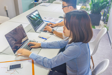 Office employees working on laptop in the office