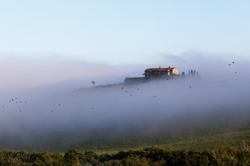 Foggy morning in Toscana, village in the mountains. Italy.