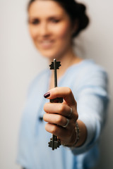 Pretty brunette girl holding keys in his hand