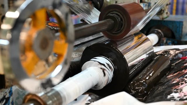 The Gravure plastic bag printer is working, see the rotating steel blocks in the color tray.