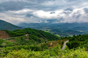 Fototapeta na wymiar View of the mountains and walley from the mountain road in Vietnam