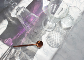 
table setting. sterile dishes and glasses on the table in the sunlight. interior kitchen.