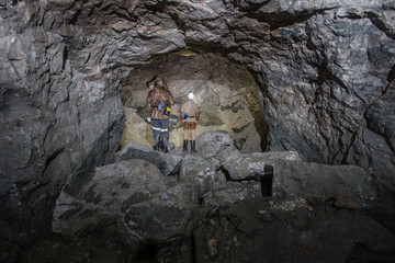 Miners in underground gold quartz mine tunnel