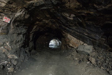 Underground gold quartz mine tunnel with light