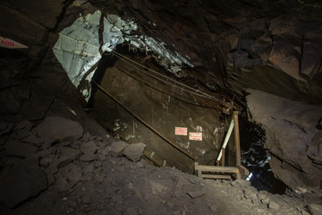 Fototapeta na wymiar Underground gold quartz mine incline tunnel with stairs ladder
