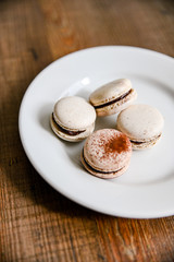 Several pieces of delicious French cookie - macrons. Chocolate flavor.