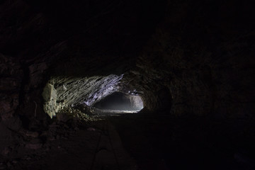 Underground gold quartz mine tunnel with light