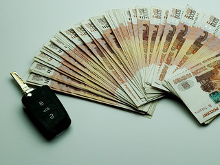 Russian banknotes and car keys on an isolated background.