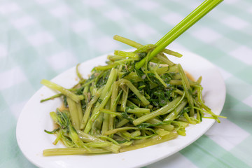 Fried water spinach dishes in restaurant