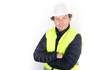 handsome man worker portrait arms crossed folded with hard hat security helmet jacket yellow over white background