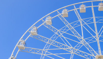 Ferris wheel in the blue sky . view the city from a height. entertainment on vacation .