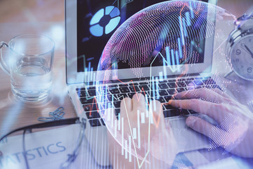 Multi exposure of market chart with man working on computer on background. Concept of financial...