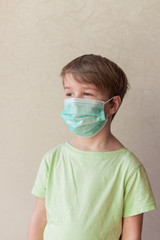 Portrait of Toddler kid wearing medical mask.A boy wearing mouth mask against pandemic. Concept of coronavirus quarantine or covid-19.  Easter stay home concept