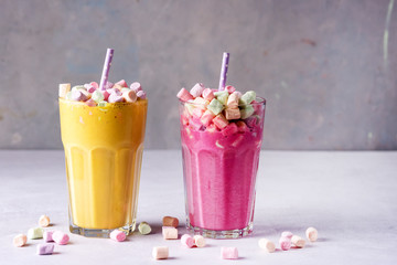 Two Glasses of Tasty Fruit Smoothies or Colored Milk Shake Decorated With Marshmallow Close Up Horizontal