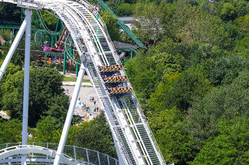 Young people screaming during a ride at roller coaster