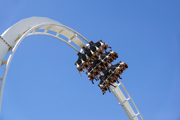 Roller coaster twisting upside down . Twist and turns of a modern steel roller coaster