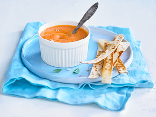 pumpkin soup in a Cup on a bright background