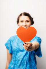 girl holding a paper heart