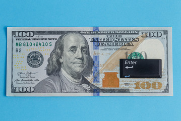 enter button on one hundred dollar banknote centered on a turquoise background