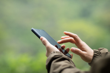 Hand taking picture with mobile phone in spring nature