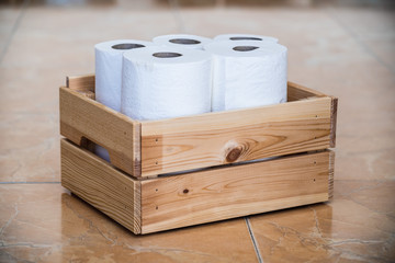 Wooden box with toilet paper rolls placed in columns